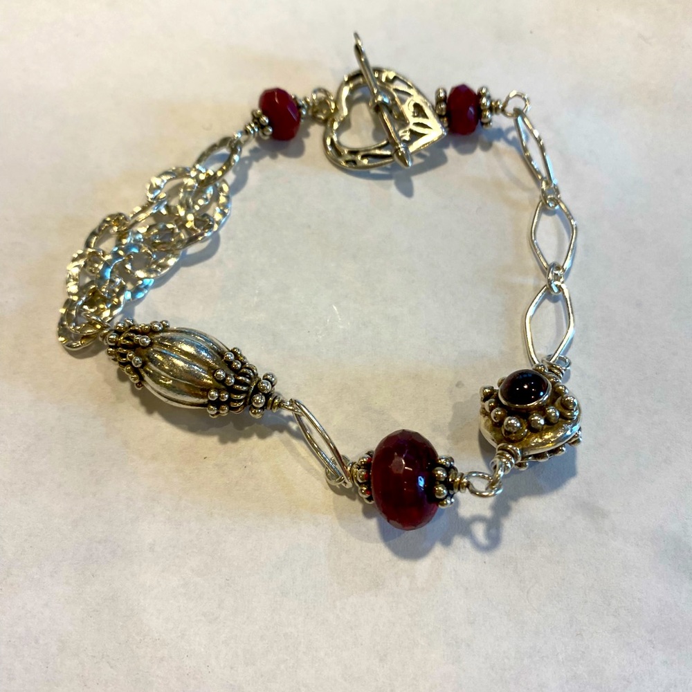 Sterling silver handcrafted bracelet adorned with garnets.